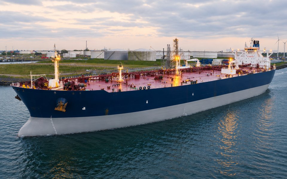 Tanker leaving port at dusk